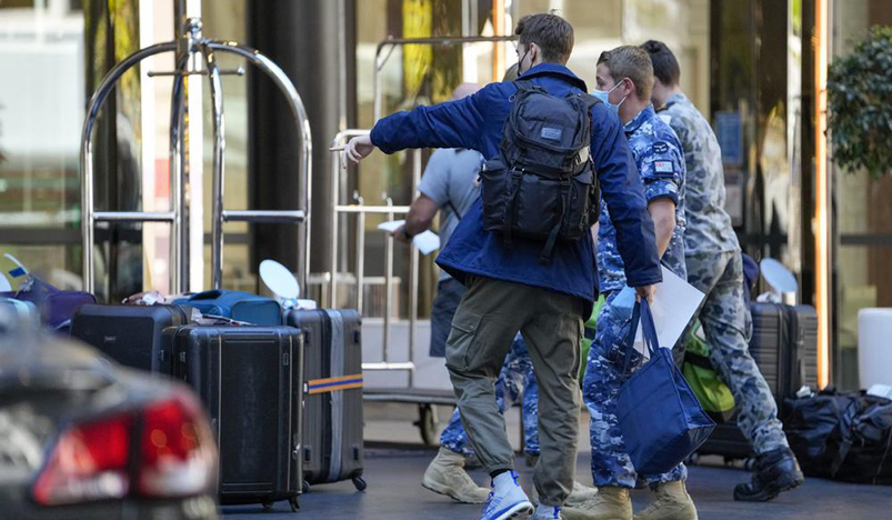 A traveler points to his luggage as he arrives at a quarantine hotel in Sydney